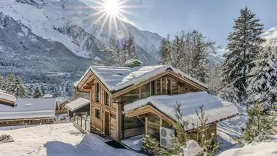 a wooden cabin with a view of a mountain at Chalet BelleVue in Chamonix-Mont-Blanc