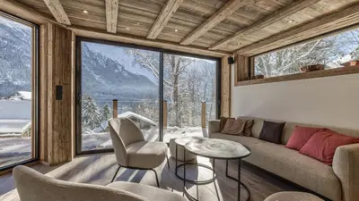 a wooden cabin with snow on the roof at Chalet BelleVue in Chamonix-Mont-Blanc