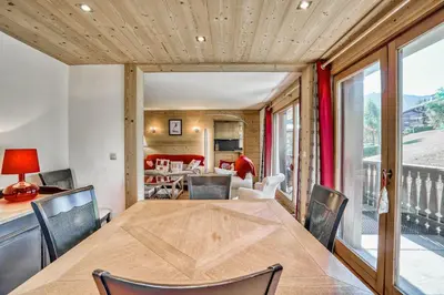 a dining room with a table and chairs at Marmots in Megève