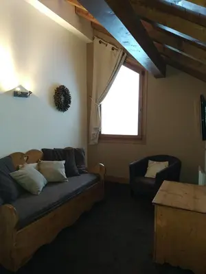 a living room with a couch and a window at Duplex résidence spa Mont-Blanc in Vallorcine