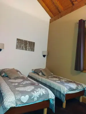 a room with two beds in a room at Duplex résidence spa Mont-Blanc in Vallorcine