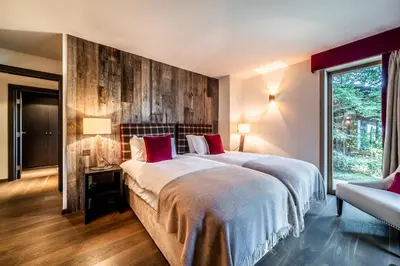 a bedroom with a large bed and a window at Chalet Purdey Combloux - BY EMERALD STAY in Combloux