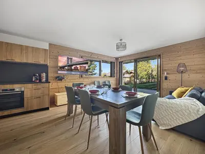 a kitchen and living room with a table and chairs at GRD005 - Appartement standing 6 pers pied de piste in Les Carroz d'Araches