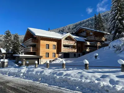 a building in the snow with snow covered parking meters at GRD005 - Appartement standing 6 pers pied de piste in Les Carroz d'Araches