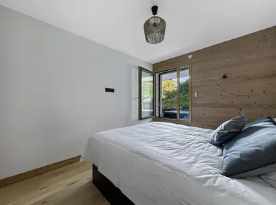 a bedroom with a large bed and a window at GRD005 - Appartement standing 6 pers pied de piste in Les Carroz d'Araches