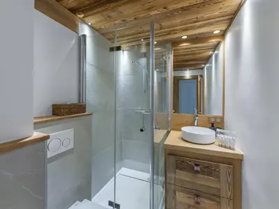 a bathroom with a glass shower and a sink at Appartement rénové à 150m des remontées, terrasse et parking couvert - FR-1-569-126 in Megève
