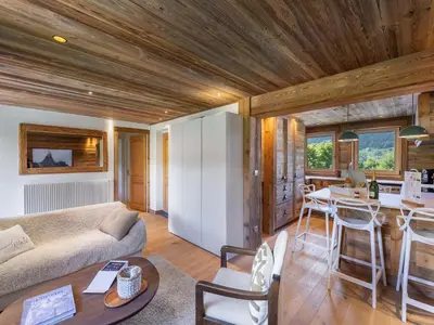a room with a bed and a desk in a house at Appartement rénové à 150m des remontées, terrasse et parking couvert - FR-1-569-126 in Megève