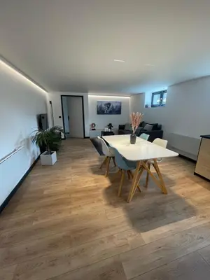 a living room with a white table and chairs at Appartement - La Meute in Magland