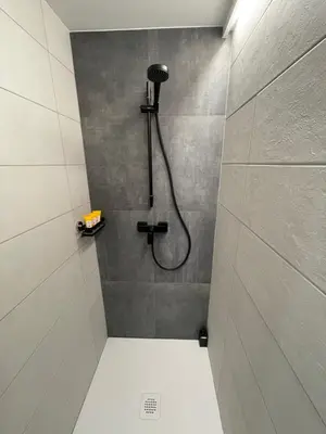 a shower with a shower head in a bathroom at Appartement - La Meute in Magland