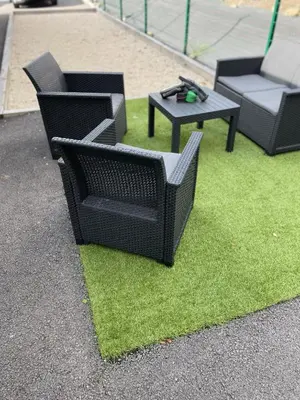 a group of chairs and a table on grass at Appartement - La Meute in Magland