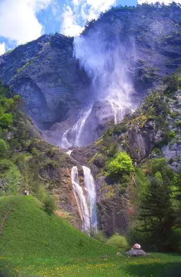 a waterfall on the side of a mountain at Appartement - La Meute in Magland
