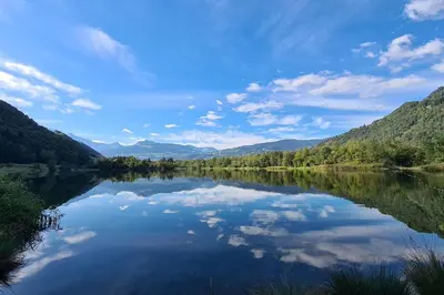 a reflection of the sky in a lake at Appartement - La Meute in Magland