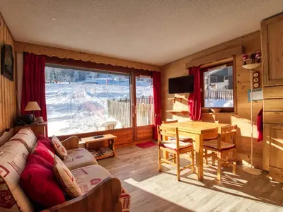 a living room with a couch and a table and a window at Appartement sud vue pistes, terrasse, équipement complet, sans animaux - FR-1-642-84 in Morillon