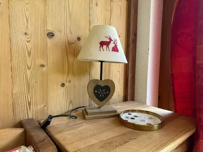 a lamp on a wooden table with a heart on it at Appartement sud vue pistes, terrasse, équipement complet, sans animaux - FR-1-642-84 in Morillon