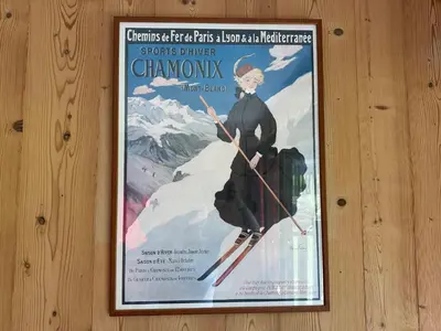 a poster of a woman on skis on a wall at Appartement sud vue pistes, terrasse, équipement complet, sans animaux - FR-1-642-84 in Morillon