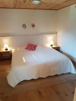 a bedroom with a white bed with a red pillow at Bethel-Mont-Blanc in Saint-Gervais-les-Bains