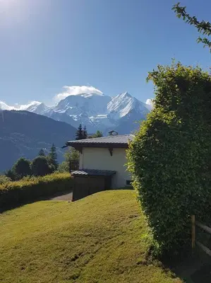 a house on a hill with a mountain in the background at Bethel-Mont-Blanc in Saint-Gervais-les-Bains