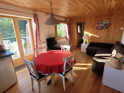 a living room with a red table and chairs at Bethel-Mont-Blanc in Saint-Gervais-les-Bains
