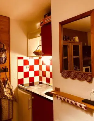 a kitchen with a red and white checkered wall at Appartement montagnard avec vue sur le Mont-Blanc in Saint-Gervais-les-Bains