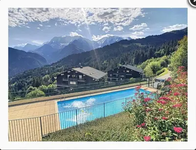 a swimming pool with mountains in the background at Appartement montagnard avec vue sur le Mont-Blanc in Saint-Gervais-les-Bains