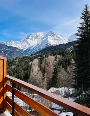 a view of a snow covered mountain from a bench at Appartement montagnard avec vue sur le Mont-Blanc in Saint-Gervais-les-Bains