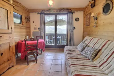 a living room with a couch and a table at Studio coin nuit style chalet in Saint-Gervais-les-Bains