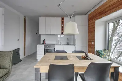 a kitchen and dining room with a wooden table and chairs at Apartment Bonatti 202 in Chamonix-Mont-Blanc
