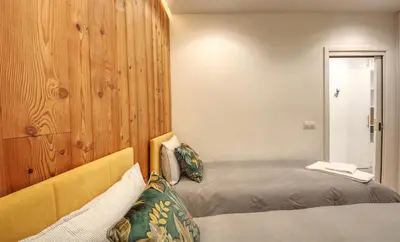 a bedroom with a bed and a wooden wall at Apartment Bonatti 202 in Chamonix-Mont-Blanc