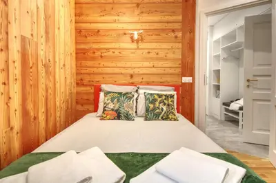a bedroom with a bed with wooden walls at Apartment Bonatti 202 in Chamonix-Mont-Blanc