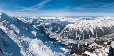 a gondola ride over a town in the mountains at Apartment Bonatti 202 in Chamonix-Mont-Blanc