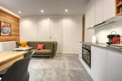 a kitchen and living room with a couch and a table at Apartment Bonatti 202 in Chamonix-Mont-Blanc