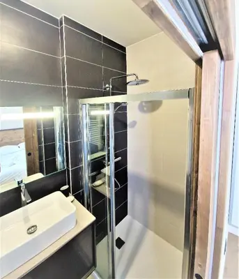 a bathroom with a sink and a shower at White Pearl Vue Mont Blanc in Chamonix-Mont-Blanc