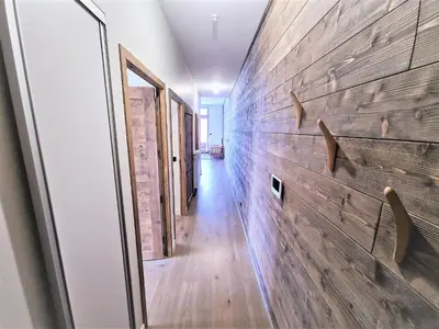 a hallway of a house with a wooden wall at White Pearl Vue Mont Blanc in Chamonix-Mont-Blanc