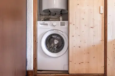 a washer and dryer in a small room at Sapins 11 - Appartement familial - Pied des pistes - Vue sur les montagnes in Les Houches