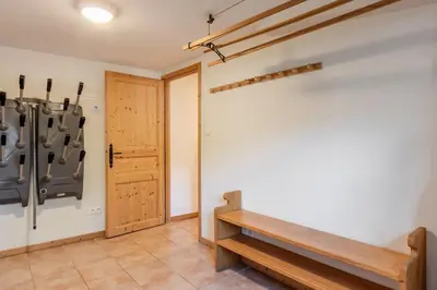 a room with a wooden bench and a door at Chalet Eveland - Proche du centre-ville - Calme in Les Houches