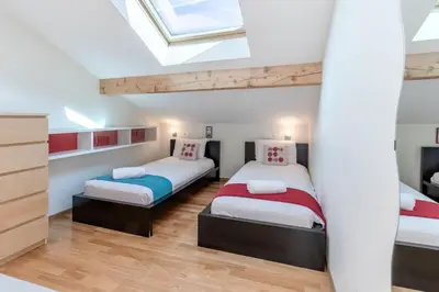 a bedroom with two beds and a skylight at Chalet Eveland - Proche du centre-ville - Calme in Les Houches