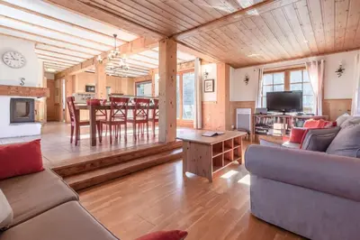 a living room with a couch and a table at Chalet Eveland - Proche du centre-ville - Calme in Les Houches