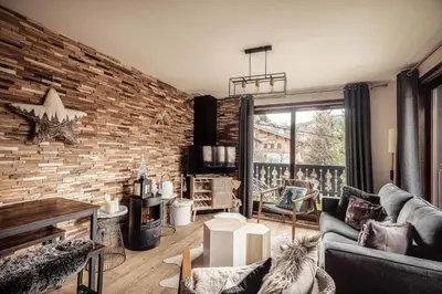 a living room with a brick wall at Appartement Uccelli - Cocoon just a stone's throw from the centre of Megève in Megève