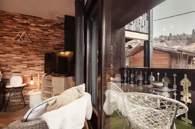 a room with two chairs and a window at Appartement Uccelli - Cocoon just a stone's throw from the centre of Megève in Megève