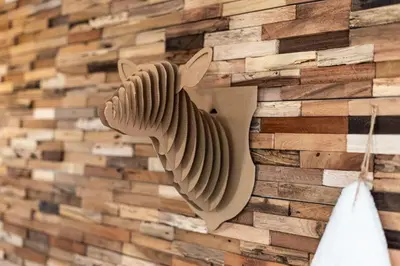 a wall made out of reclaimed wood with a bird sculpture at Appartement Uccelli - Cocoon just a stone's throw from the centre of Megève in Megève