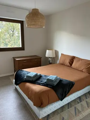 a bedroom with a bed with two towels on it at Appartement 109 in Sallanches