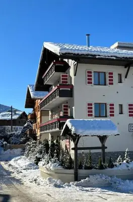 a large building with snow on top of it at RED LODGE in Megève