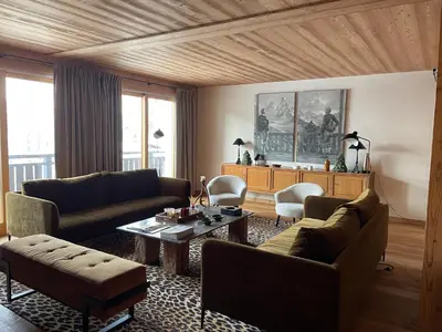 a living room with two couches and a table at RED LODGE in Megève