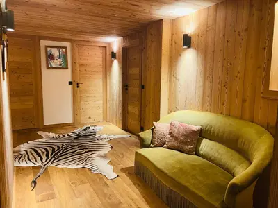 a living room with a couch and a zebra rug at RED LODGE in Megève