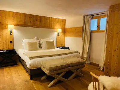 a bedroom with a large bed and a window at RED LODGE in Megève
