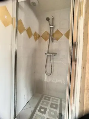 a shower with a glass door in a bathroom at rous 03 in Les Carroz d'Araches