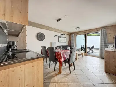 a kitchen and dining room with a table and chairs at rous 03 in Les Carroz d'Araches