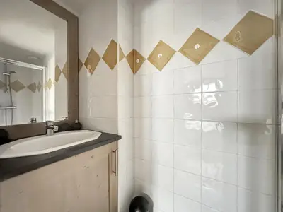 a bathroom with a sink and a mirror at rous 03 in Les Carroz d'Araches