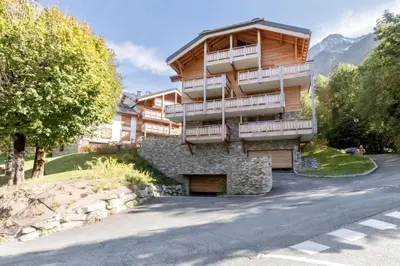 an apartment building with a balcony on the side of a road at Terra Losa 2 - Quiet and modern apartment - City center in Les Houches
