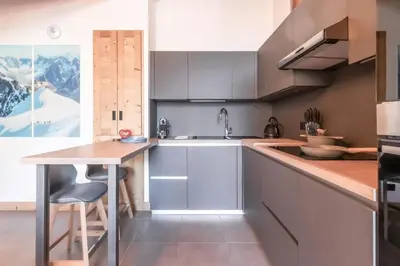 a kitchen with a sink and a counter top at Terra Losa 2 - Quiet and modern apartment - City center in Les Houches